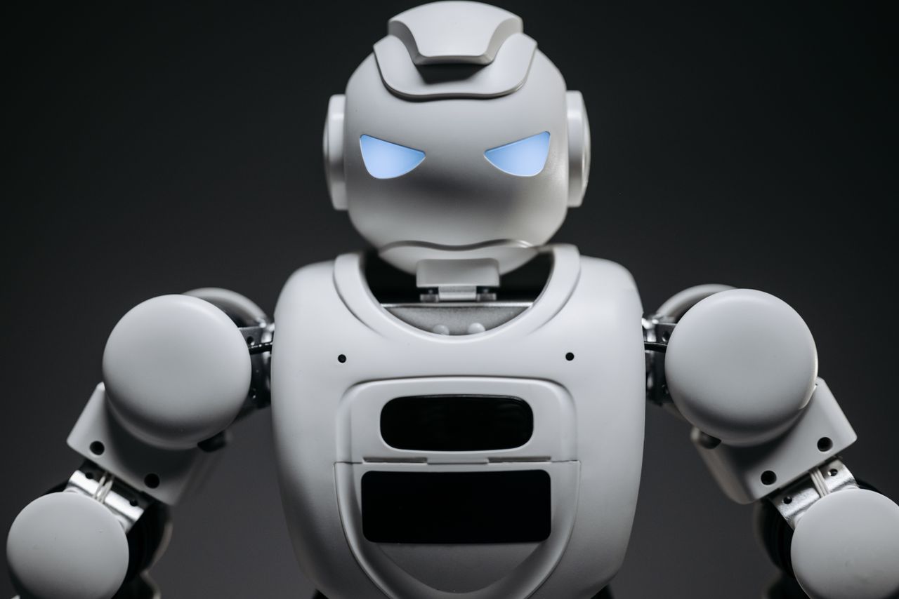 ours-journey Detailed studio shot of a modern robotic toy with a dark background, showcasing technological design.