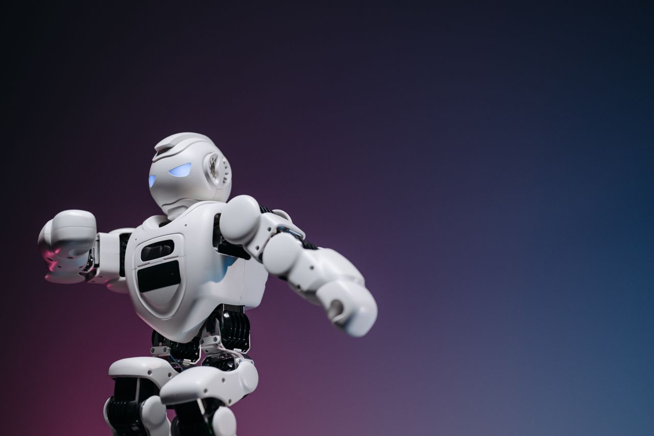 our-experience Close-up of a futuristic robotic toy against a gradient background, symbolizing innovation and technology.